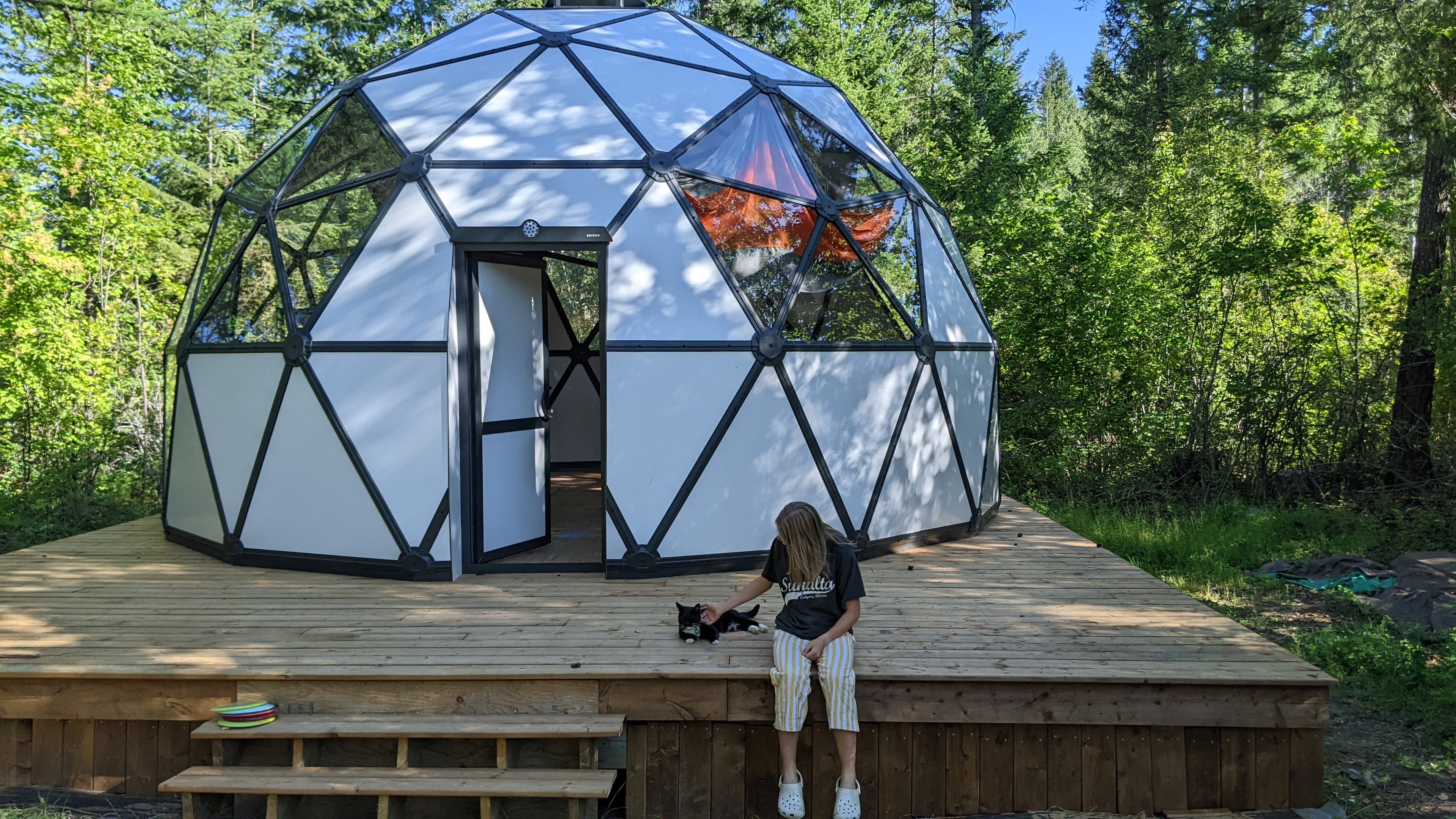 Front shot of dome with child and cat on deck